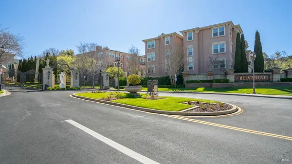 a view of a big building with a big yard and large trees