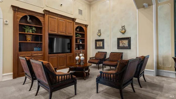 a room with furniture a flat screen tv and windows