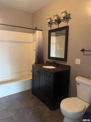 a bathroom with a toilet a sink and bathtub