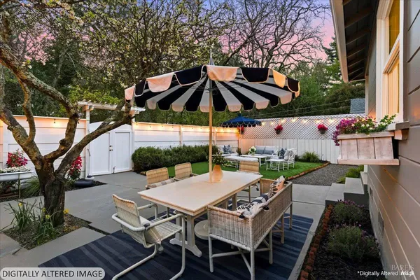 a view of a patio with furniture and a backyard