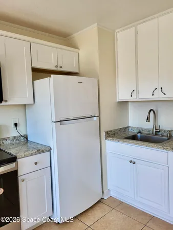 a white toilet sitting next to a shower