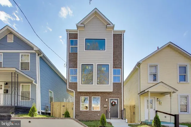 a view of a brick house with many windows