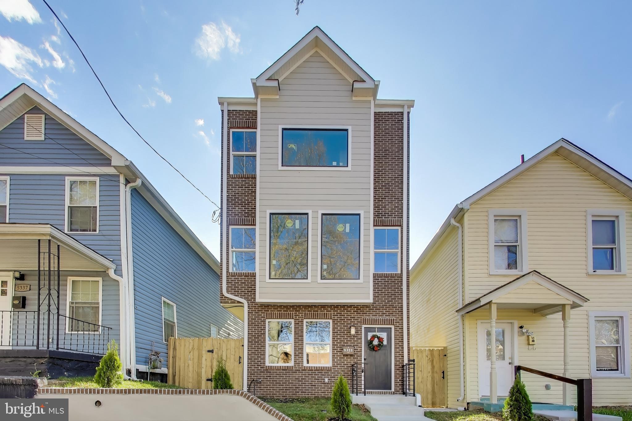 a view of a brick house with many windows