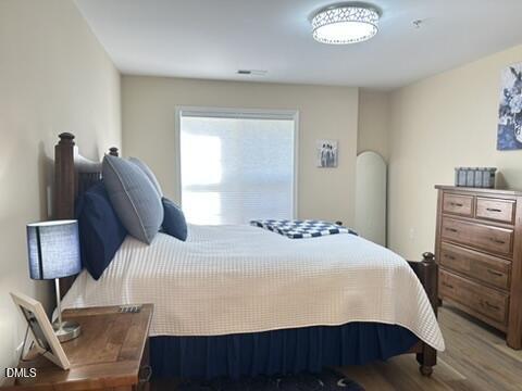 2510 Friedland Place, Unit 102 Raleigh, NC 27617 - Photo 28 of 42 a bedroom with a bed dresser and a window