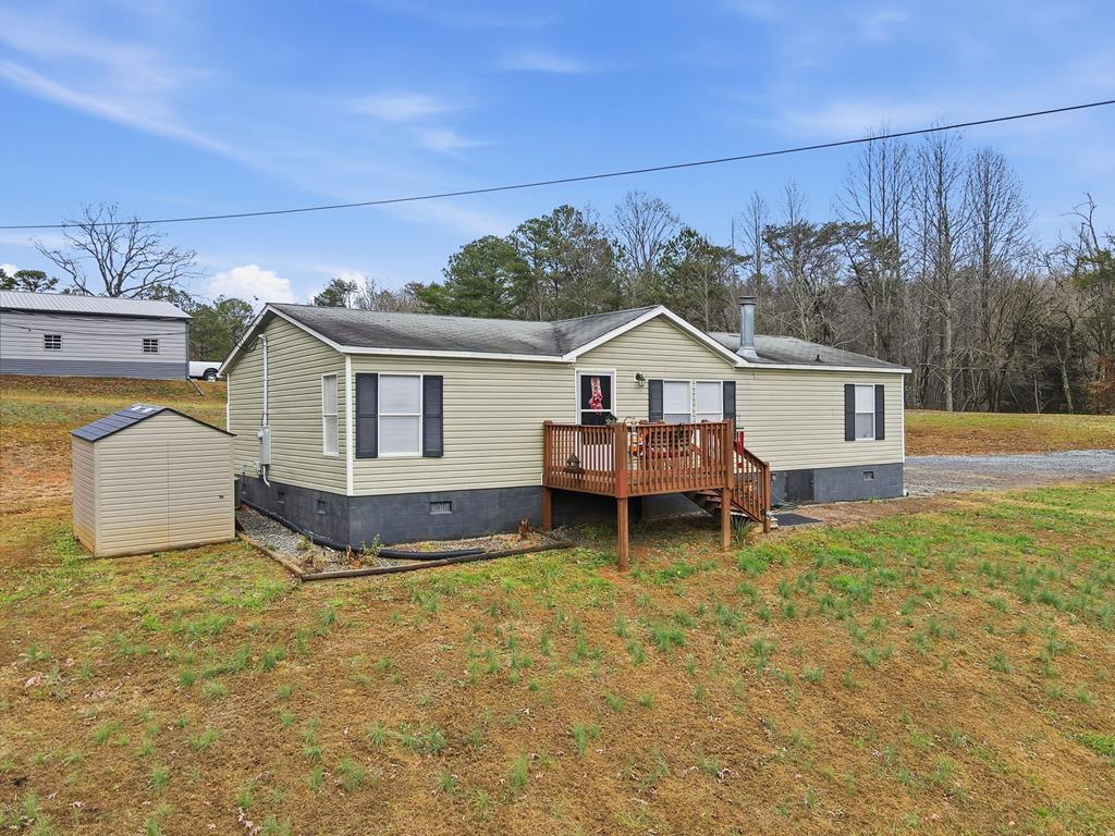 a view of a house with backyard porch and wooden fence