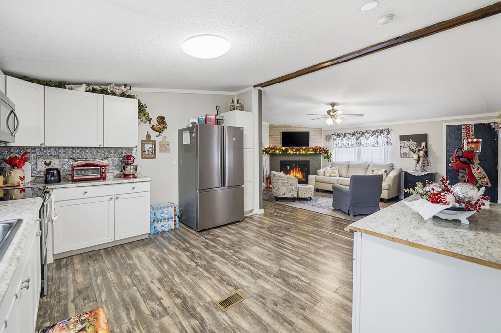 194 Burgess Road Ellijay, GA 30540 - Photo 11 of 32 a kitchen with refrigerator and cabinets