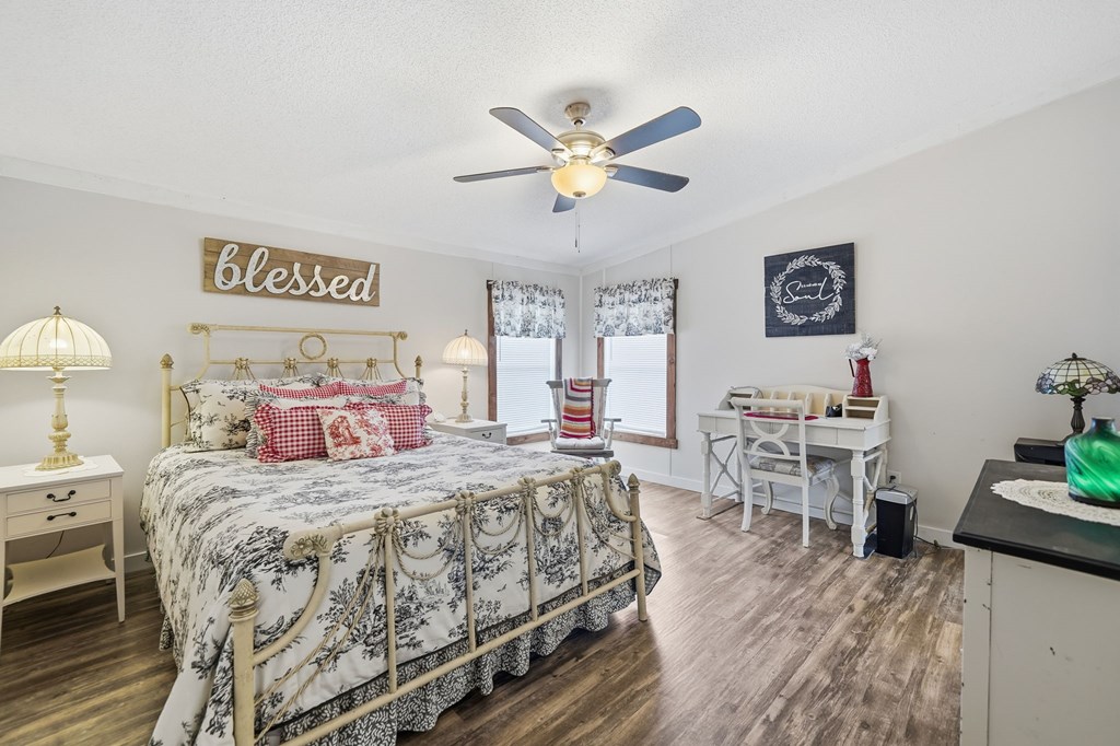 194 Burgess Road Ellijay, GA 30540 - Photo 12 of 32 a bedroom with a bed and a table in it