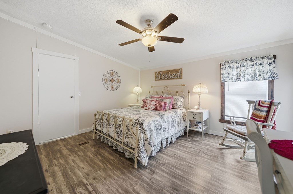 194 Burgess Road Ellijay, GA 30540 - Photo 13 of 32 a bedroom with a bed and wooden floor