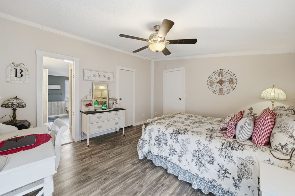 194 Burgess Road Ellijay, GA 30540 - Photo 14 of 32 a bedroom with a bed and a chandelier