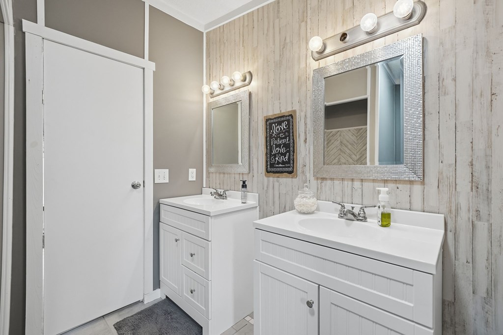 194 Burgess Road Ellijay, GA 30540 - Photo 16 of 32 a bathroom with a double vanity sink and a mirror