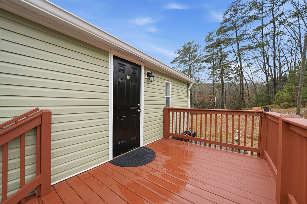 194 Burgess Road Ellijay, GA 30540 - Photo 26 of 32 a view of backyard with a deck and wooden floor
