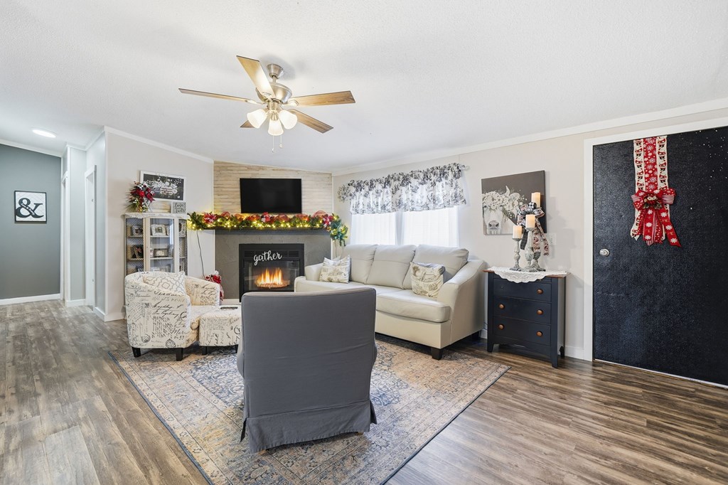 194 Burgess Road Ellijay, GA 30540 - Photo 4 of 32 a living room with furniture a fireplace and a flat screen tv
