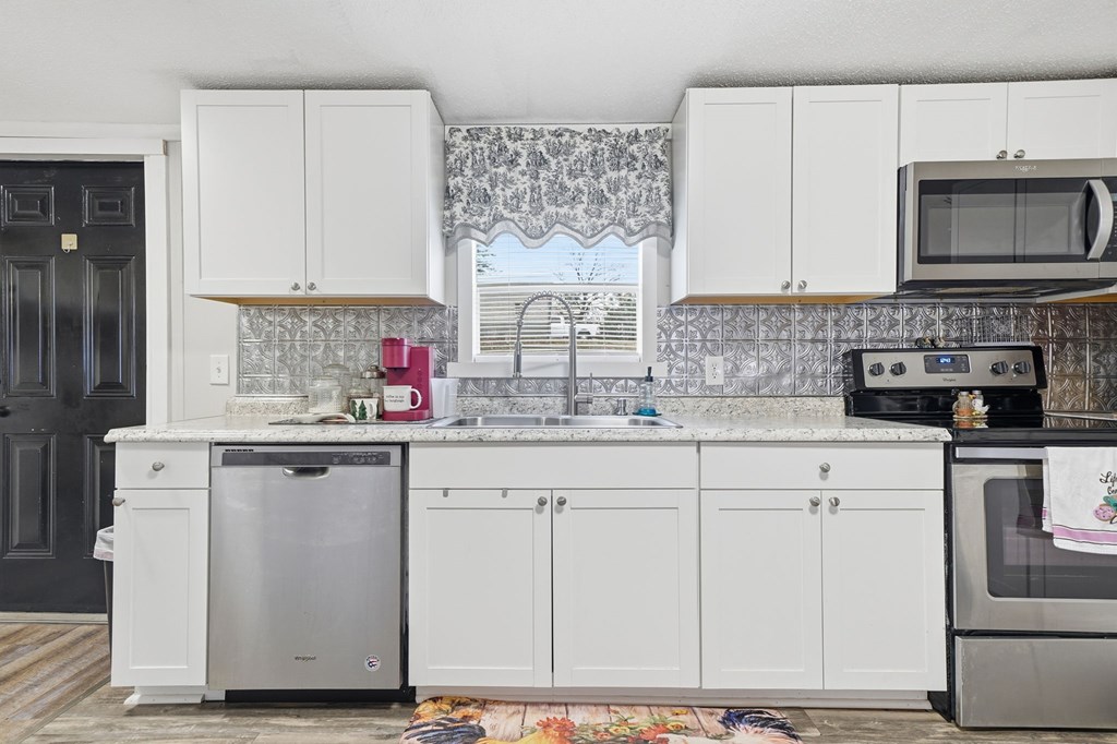 194 Burgess Road Ellijay, GA 30540 - Photo 10 of 32 a kitchen with granite countertop a sink stainless steel appliances and cabinets