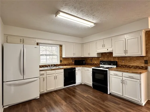 a kitchen with a white cabinets and white appliances