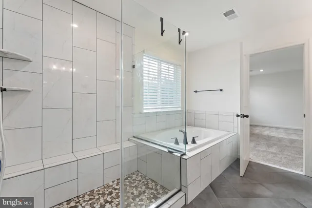a bathroom with a bathtub and shower