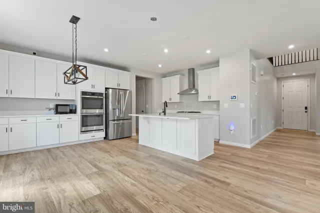 a kitchen with refrigerator and cabinets