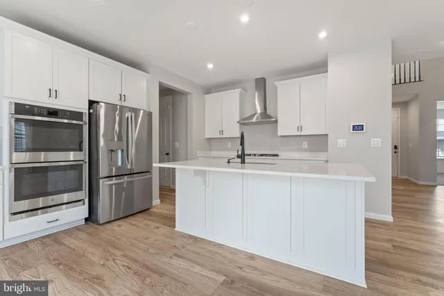 a kitchen with stainless steel appliances a refrigerator sink and microwave