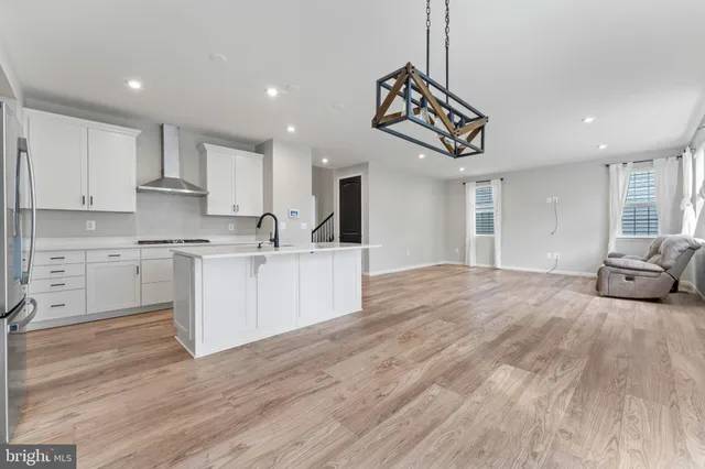 a kitchen with kitchen island a sink stainless steel appliances and cabinets