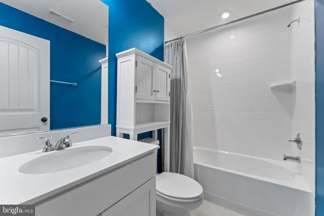 a bathroom with a sink toilet vanity and shower