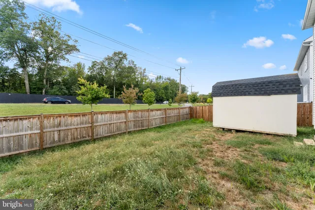 a view of a backyard with a fence