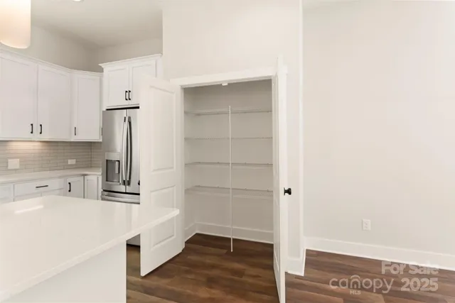 a kitchen with stainless steel appliances a refrigerator and cabinets