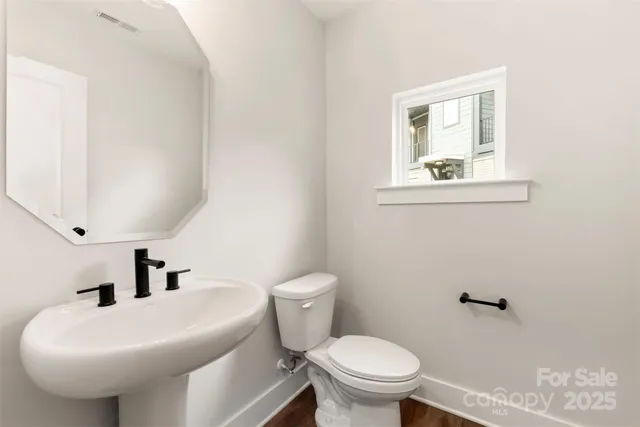 a bathroom with a sink a mirror and a toilet