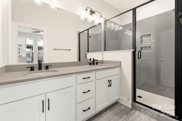 a bathroom with a granite countertop sink mirror and double