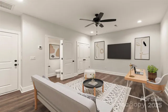 a living room with furniture and a wooden floor