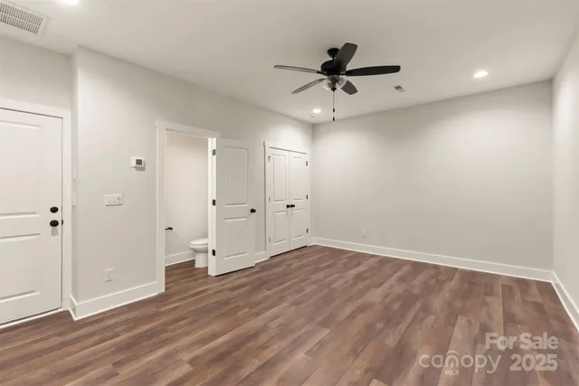 a view of an empty room and wooden floor