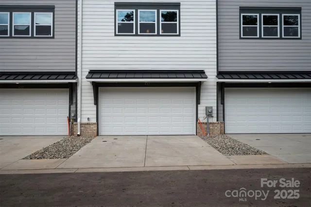 a front view of residential houses with yard