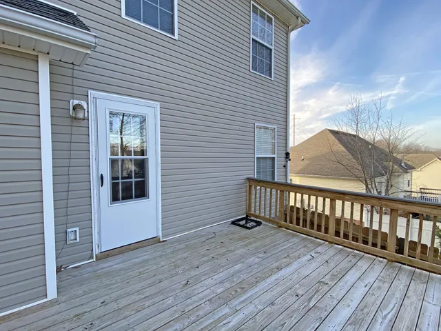 a view of a house with wooden deck