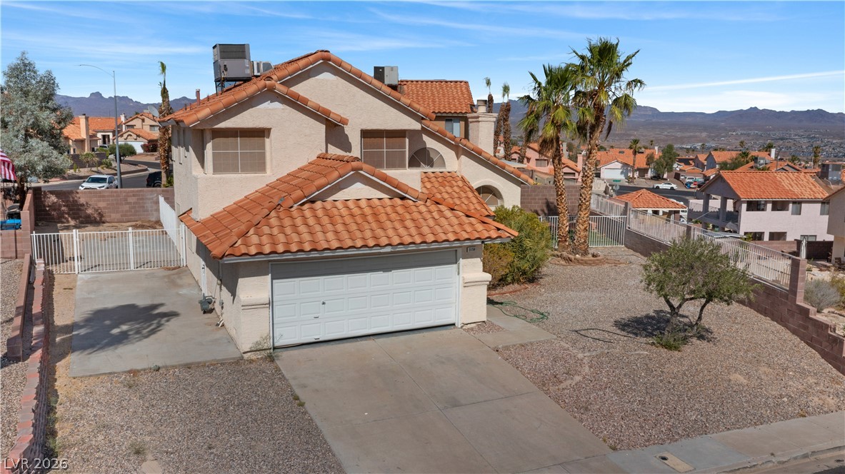 3156 Terrace View Drive Laughlin, NV 89029 - Photo 74 of 94 A terracotta-roofed residence with desert landscaping and an attached garage offers mountain views.