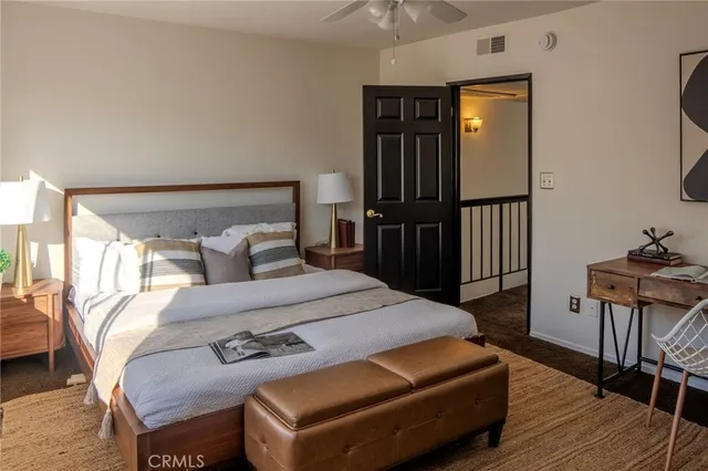 a bedroom with a bed a mirror and furniture