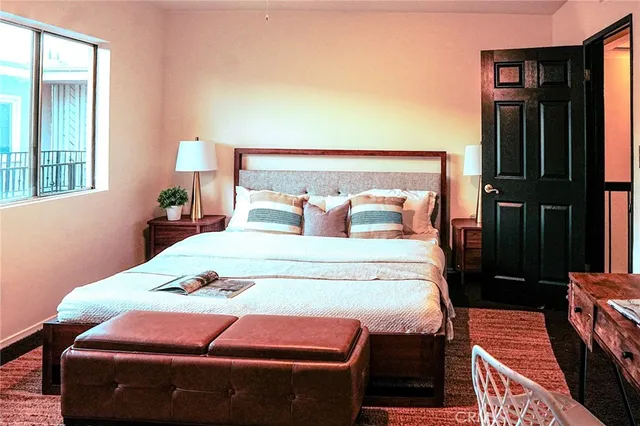 a bedroom with a bed and a night stand