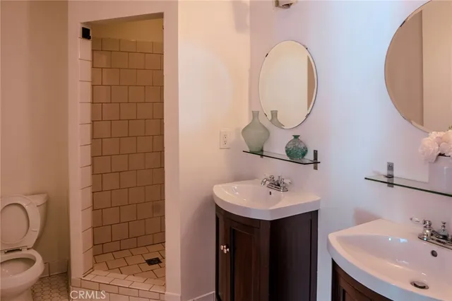 a bathroom with a sink mirror and toilet
