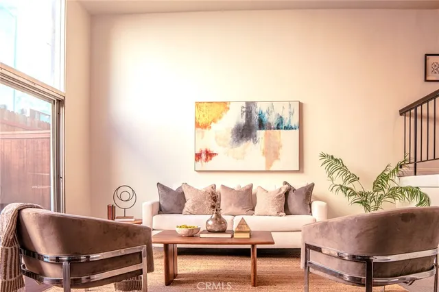 a living room with furniture and a potted plant