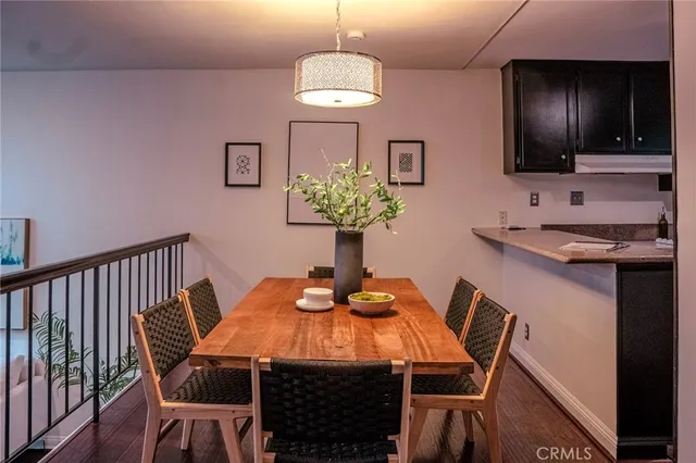 a dining room with furniture and wooden floor