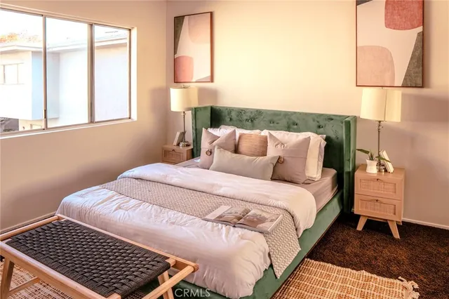 a bedroom with a bed and a window with lamp