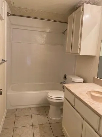 a bathroom with a sink a toilet and bathtub