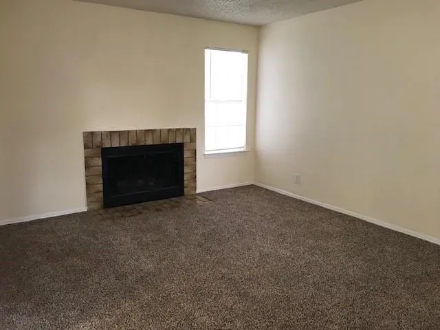 an empty room with a fireplace