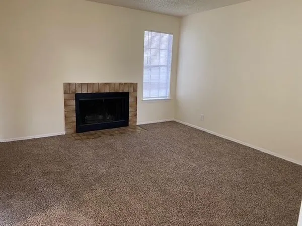 a view of empty room with a fireplace
