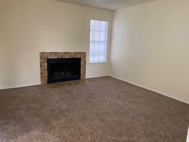 a view of empty room with a fireplace