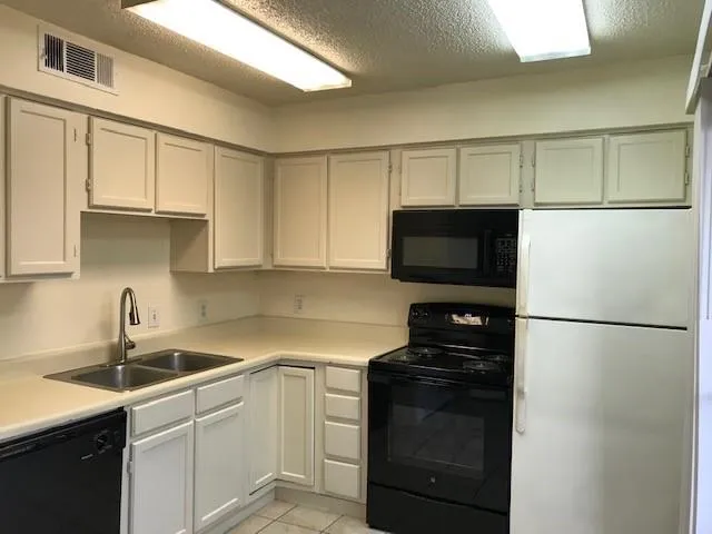 a kitchen with a sink and a refrigerator