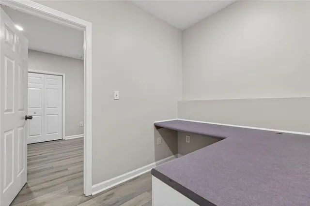 a view of an empty room with wooden floor