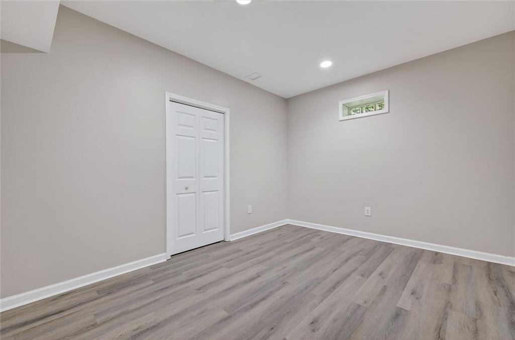 641 Olde Ivy Way Stone Mountain, GA 30087 - Photo 29 of 40 a view of an empty room with wooden floor