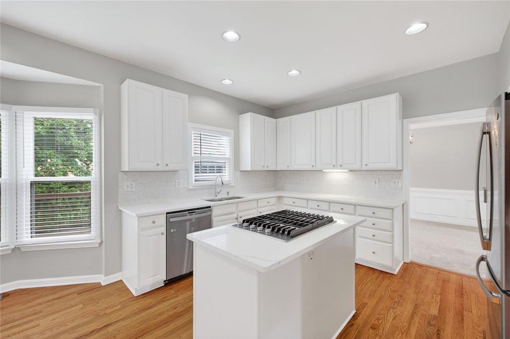 641 Olde Ivy Way Stone Mountain, GA 30087 - Photo 3 of 40 a kitchen with a refrigerator a sink and cabinets