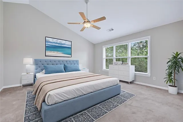 a bedroom with a large bed and a window