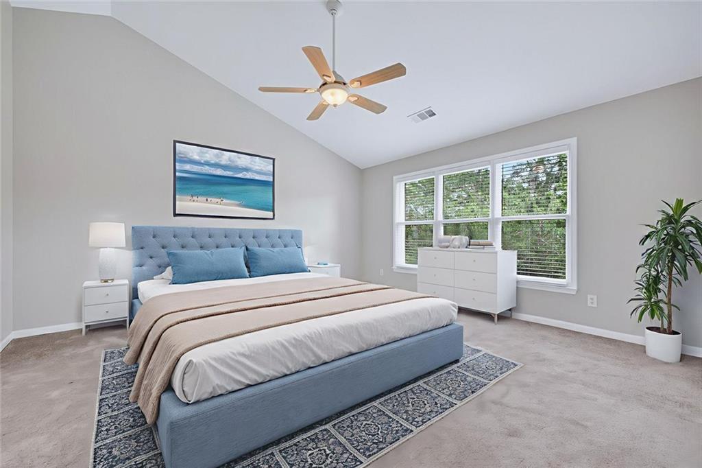 641 Olde Ivy Way Stone Mountain, GA 30087 - Photo 7 of 40 a bedroom with a large bed and a window