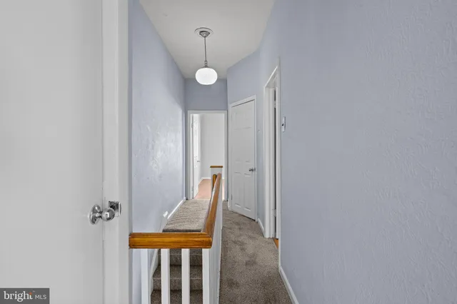 a view of a room with wooden floor and windows