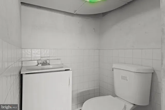 a bathroom with a granite countertop toilet sink and mirror